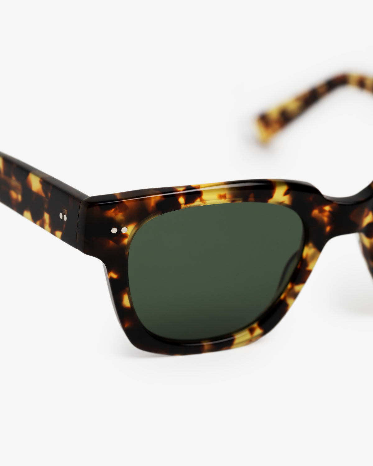 Close-up of Gallo Sunglasses with green tinted lenses and tortoiseshell frame on a white background.