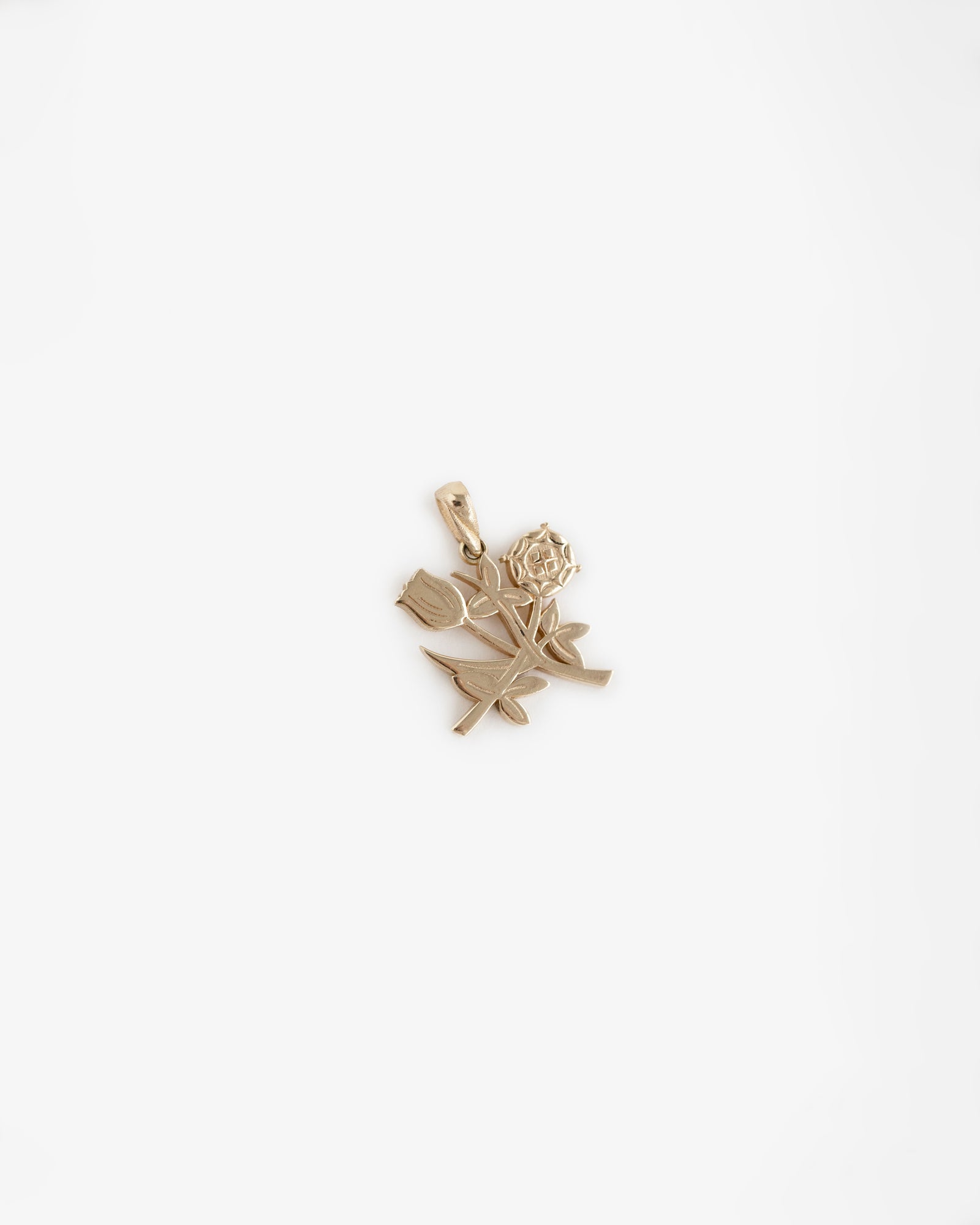 14Kt Gold Pendant shaped like a rose with stem and leaves, shown on a plain white background.
