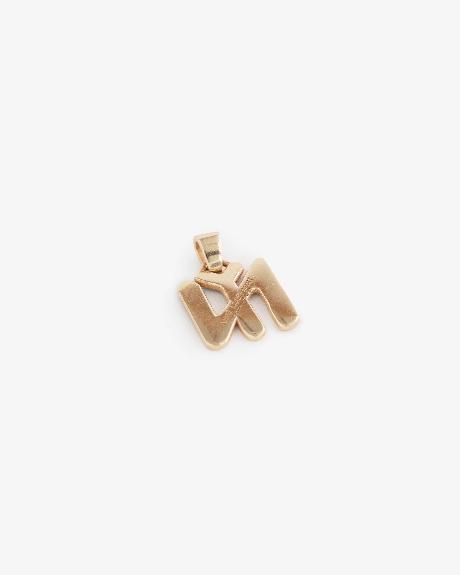 14Kt Gold Pendant shaped like the Hebrew letter shin on a white background.