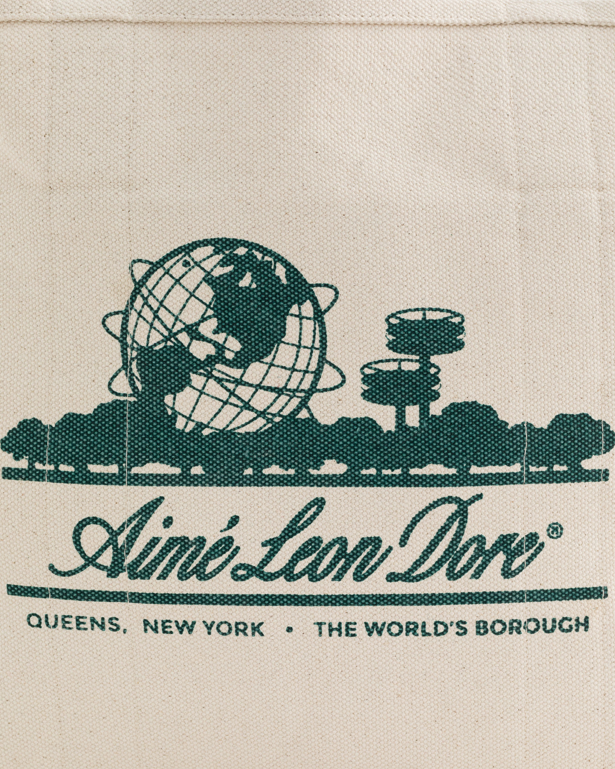 Illustration of a globe and buildings with text: Small Unisphere Tote Bag, Aimé Leon Dore, Queens, New York.