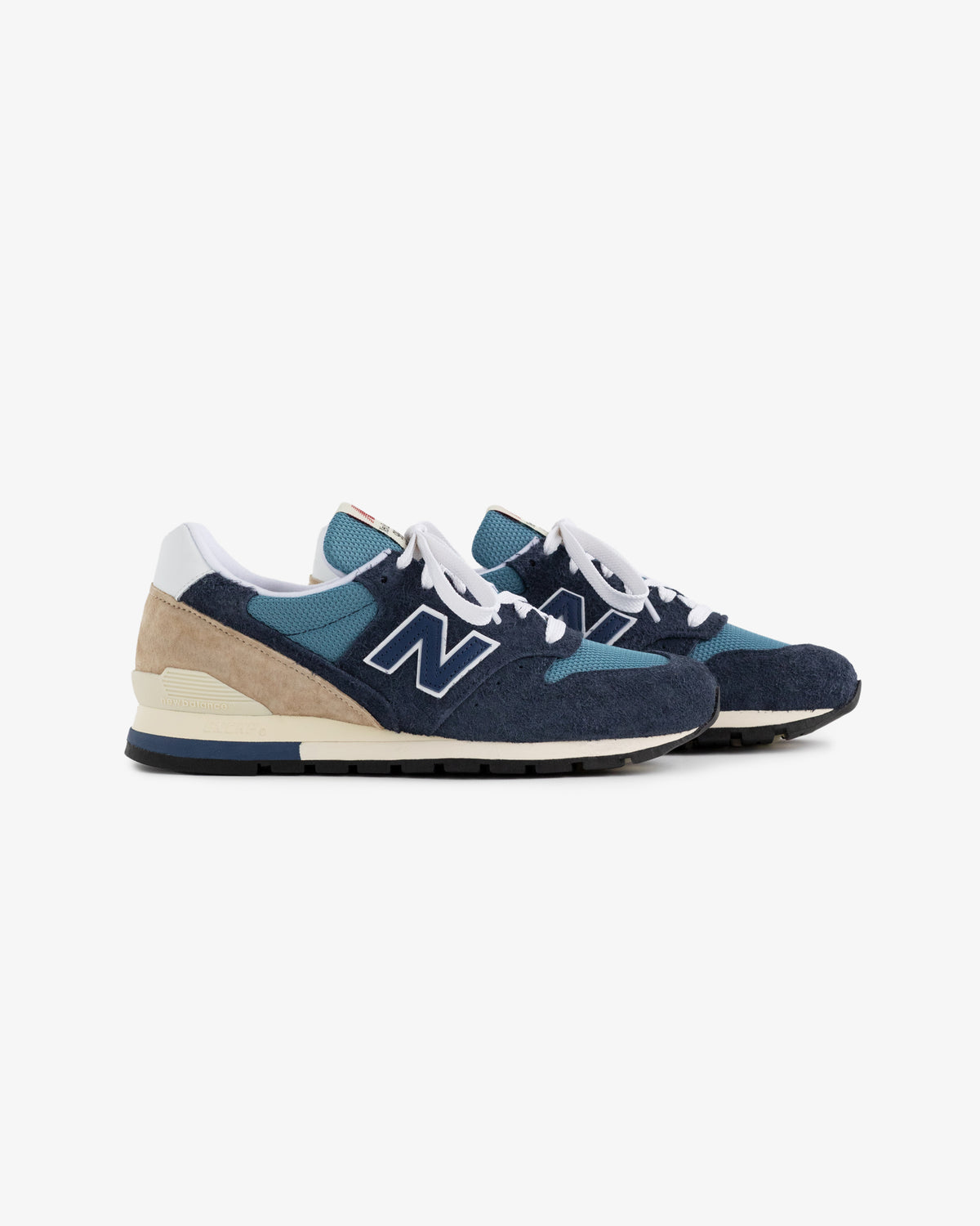New Balance Made in USA 996 sneakers in blue and beige with white laces on a white background.