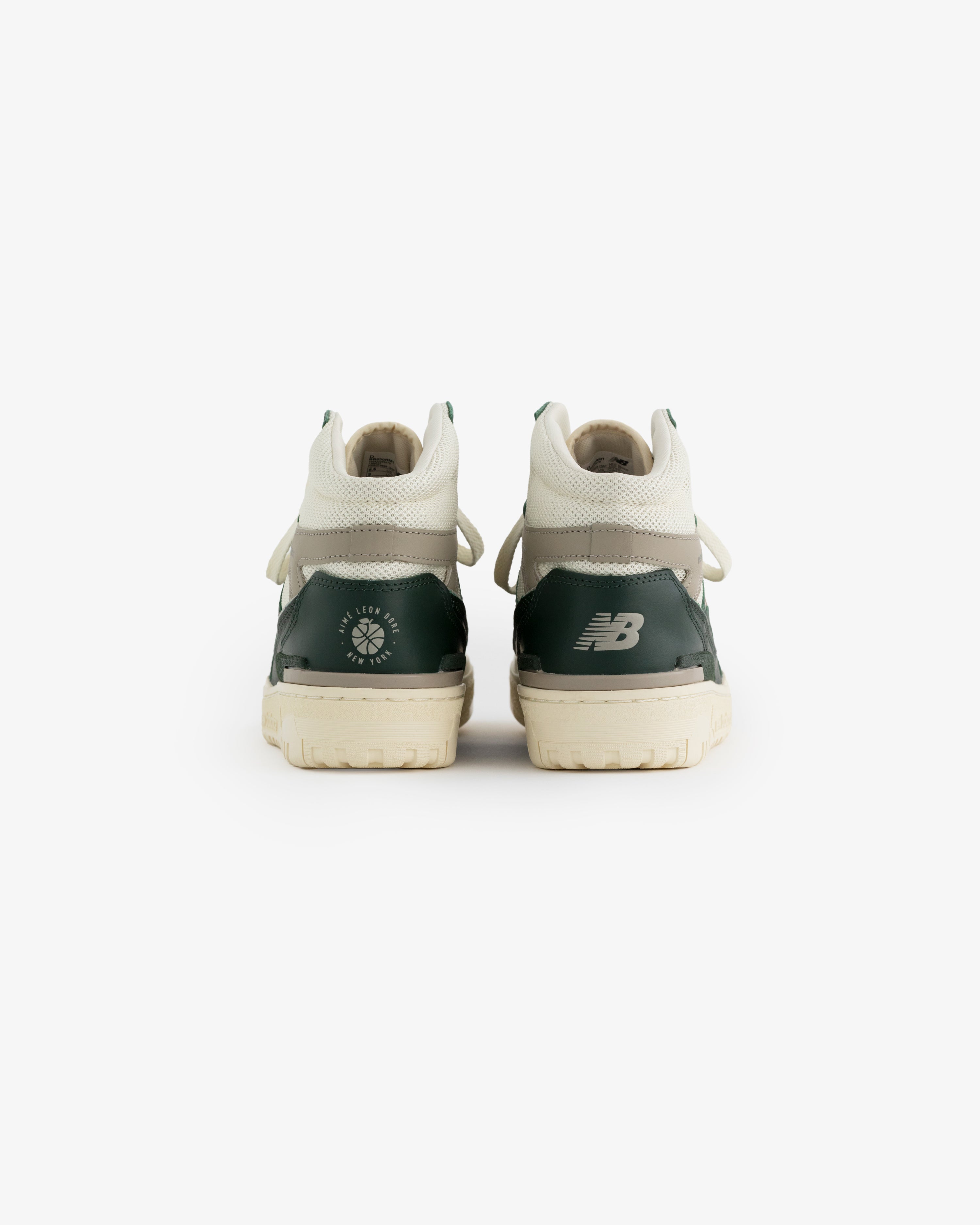 ALD / New Balance 650R green and white sneakers shown from the back on a white background.