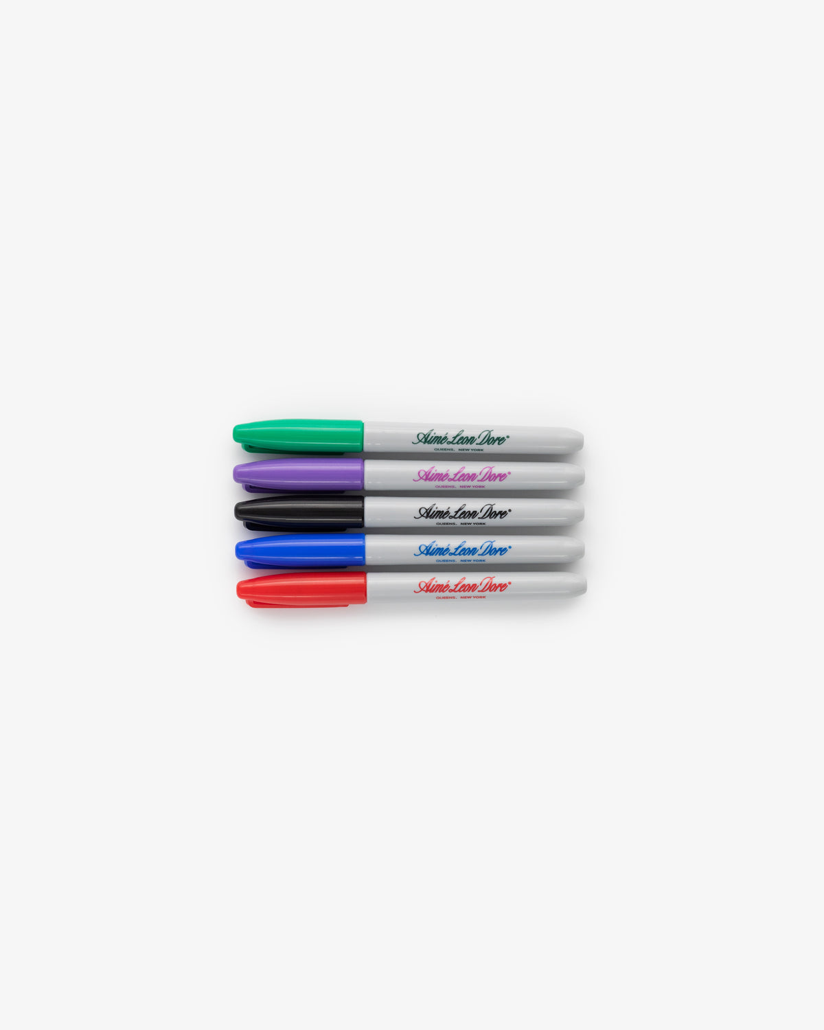 Sharpie 5 Pack markers in green, purple, black, and red with caps, arranged in a row on a white background.