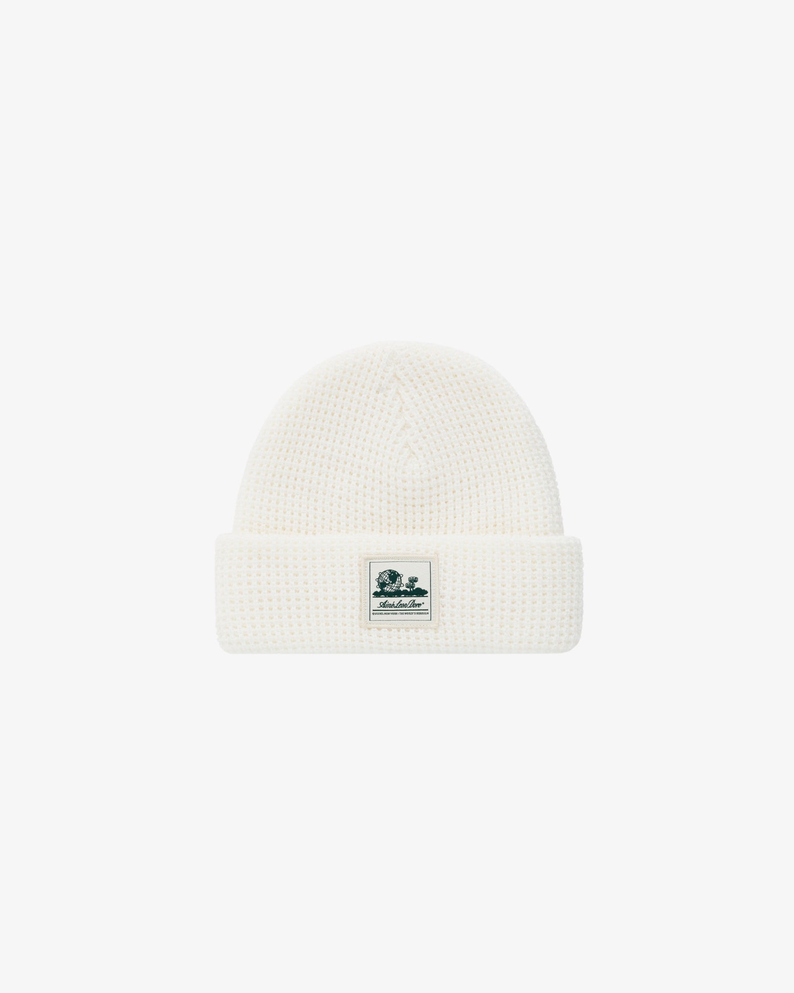 Waffle Knit Beanie in white with folded brim and small green and white logo patch on the front.